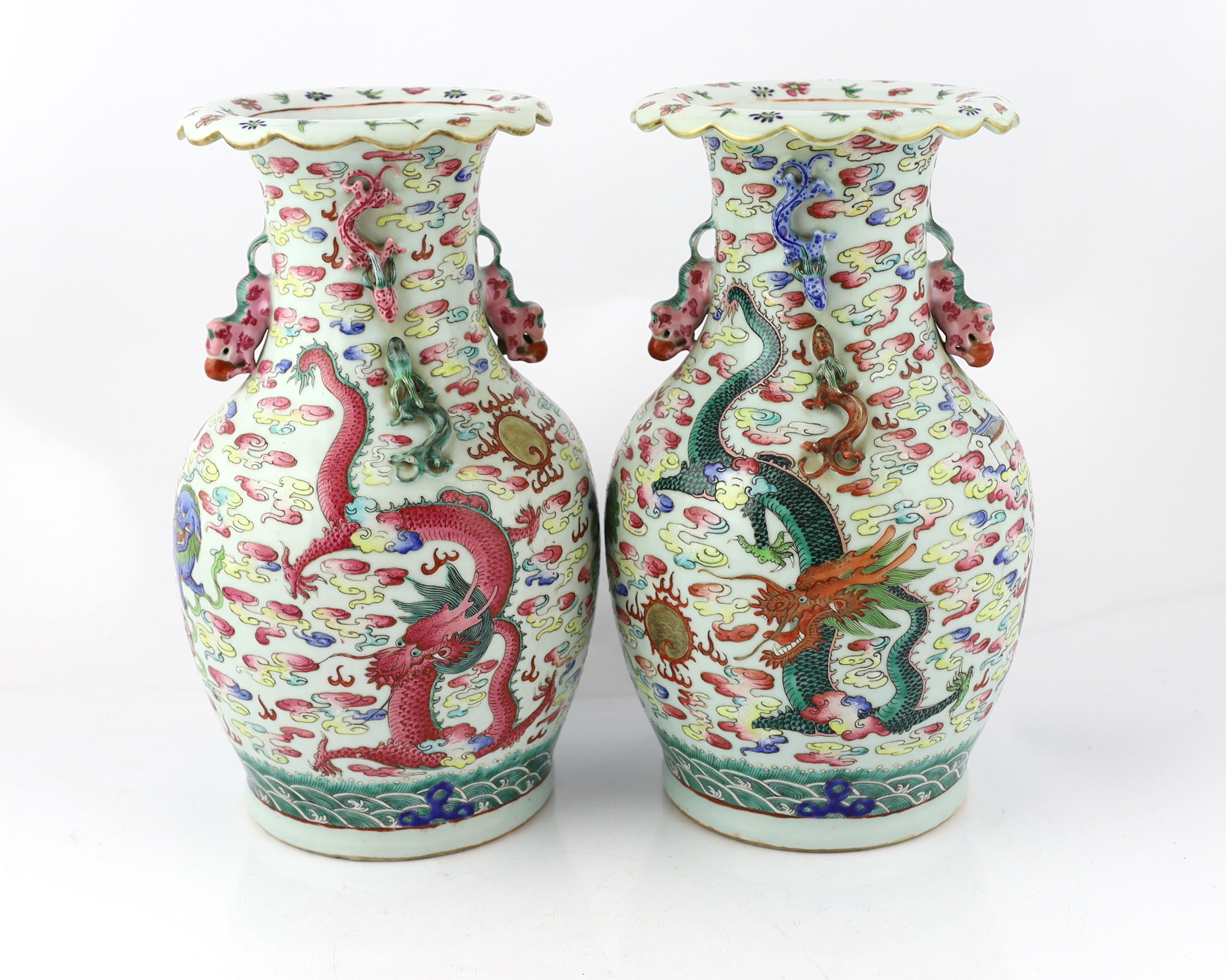 A pair of Chinese enamelled porcelain 'dragon and Buddhist lion' vases, 19th century, body crack to one vase